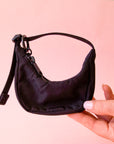 A mini black crescent bag shaped bag charm. 