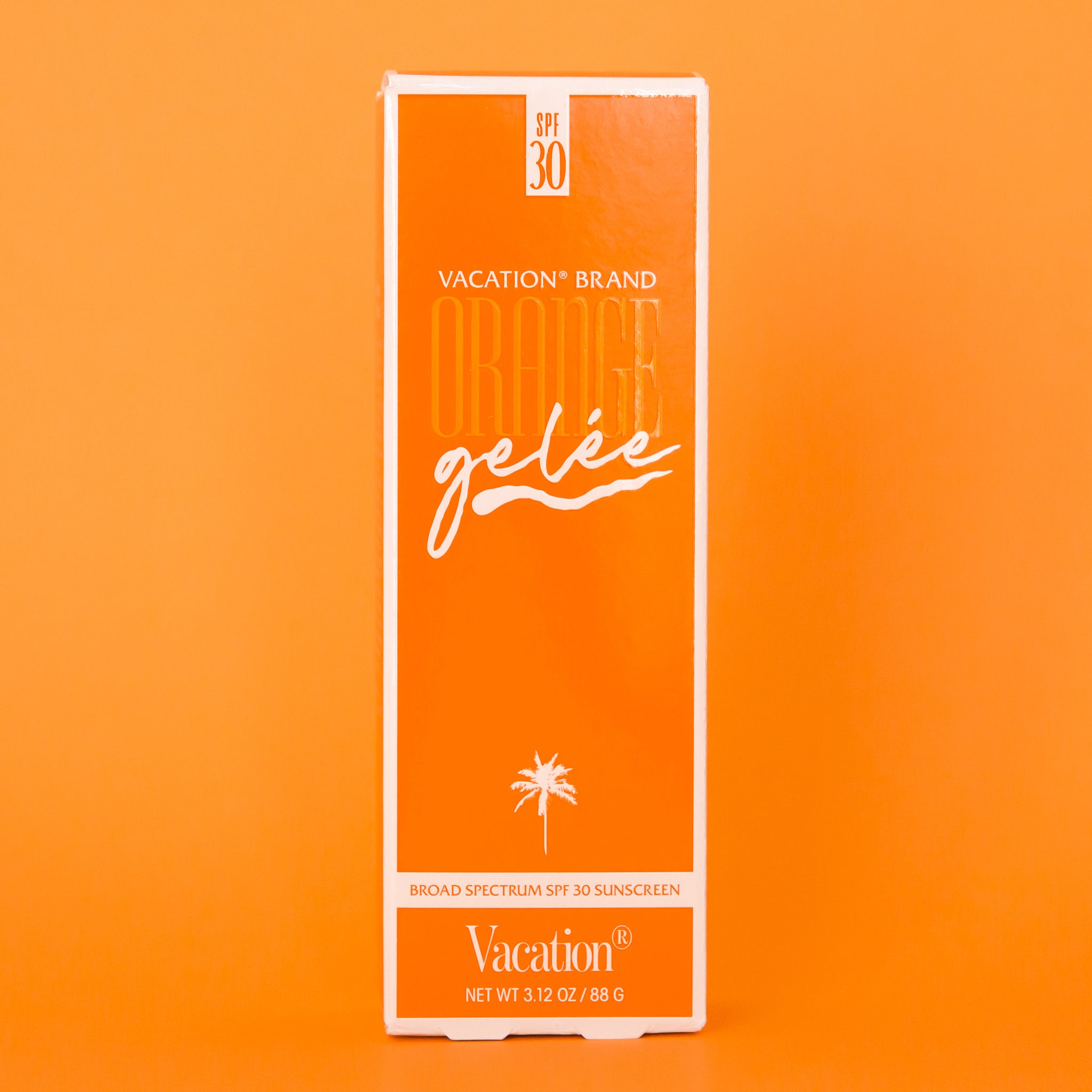 The orange packaging of the white tube of orange gelee sunscreen. 