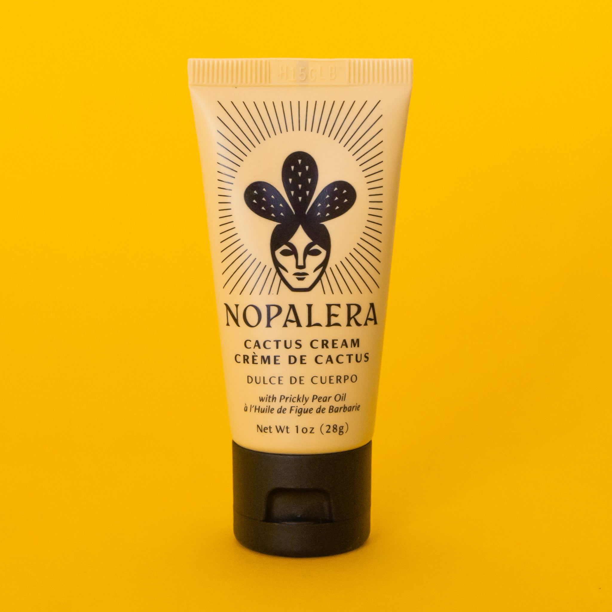 On a yellow background is a tan colored tube of hand cream with black text that reads, &quot;Nopalera Cactus Cream&quot;. 