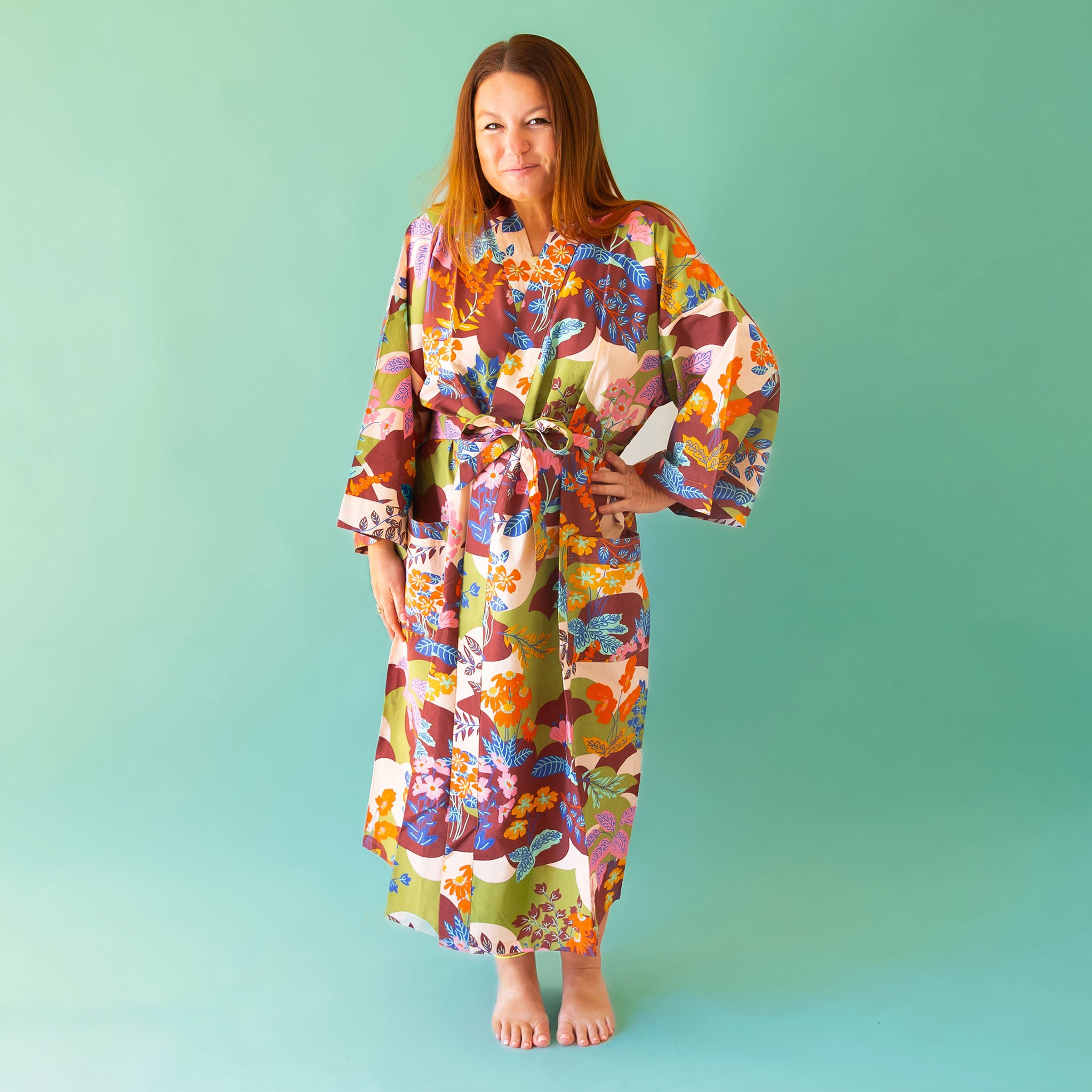 On a green background is a multi colored cotton bath robe.