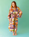 On a green background is a multi colored cotton bath robe.