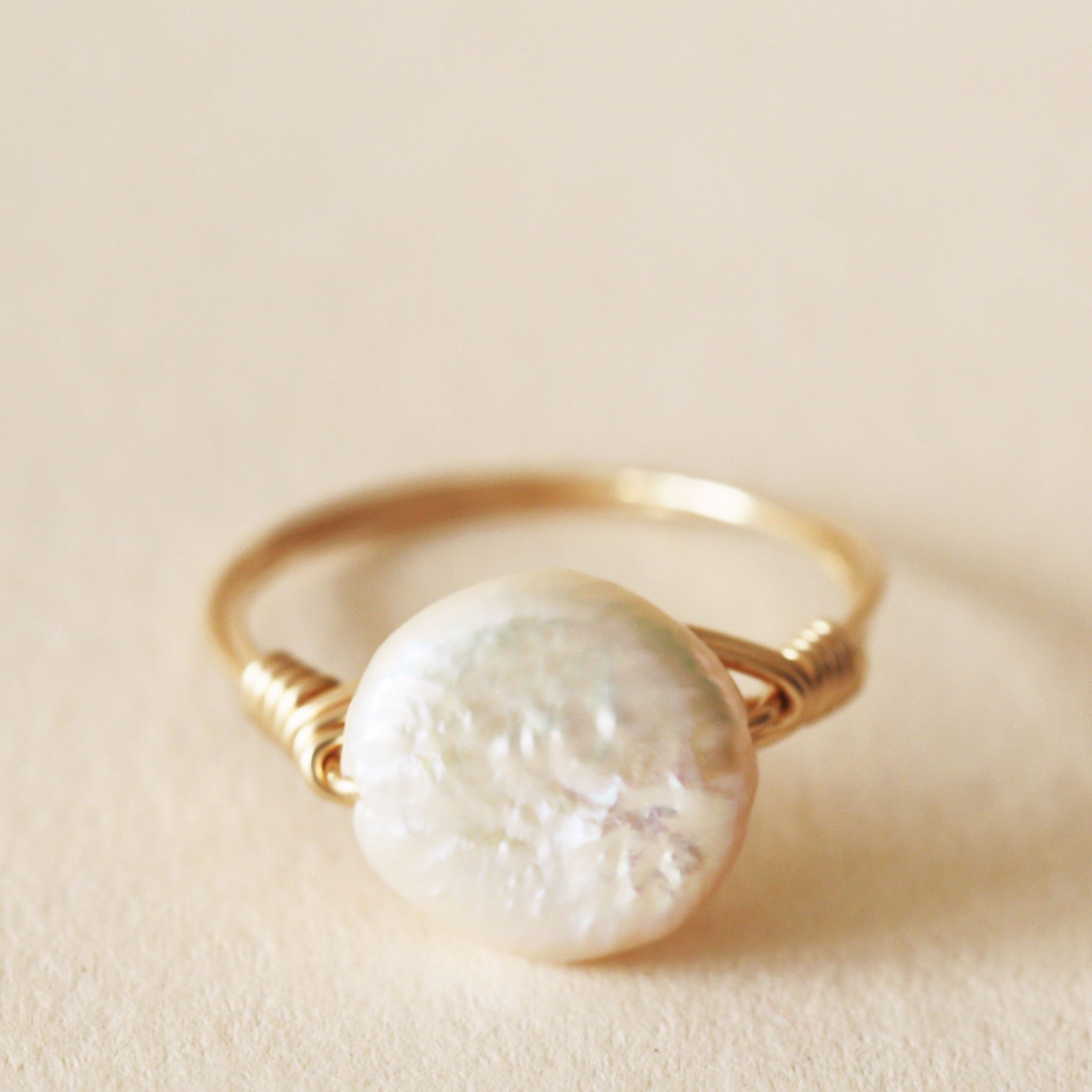 A gold ring, with a circle freshwater pearl in the center.