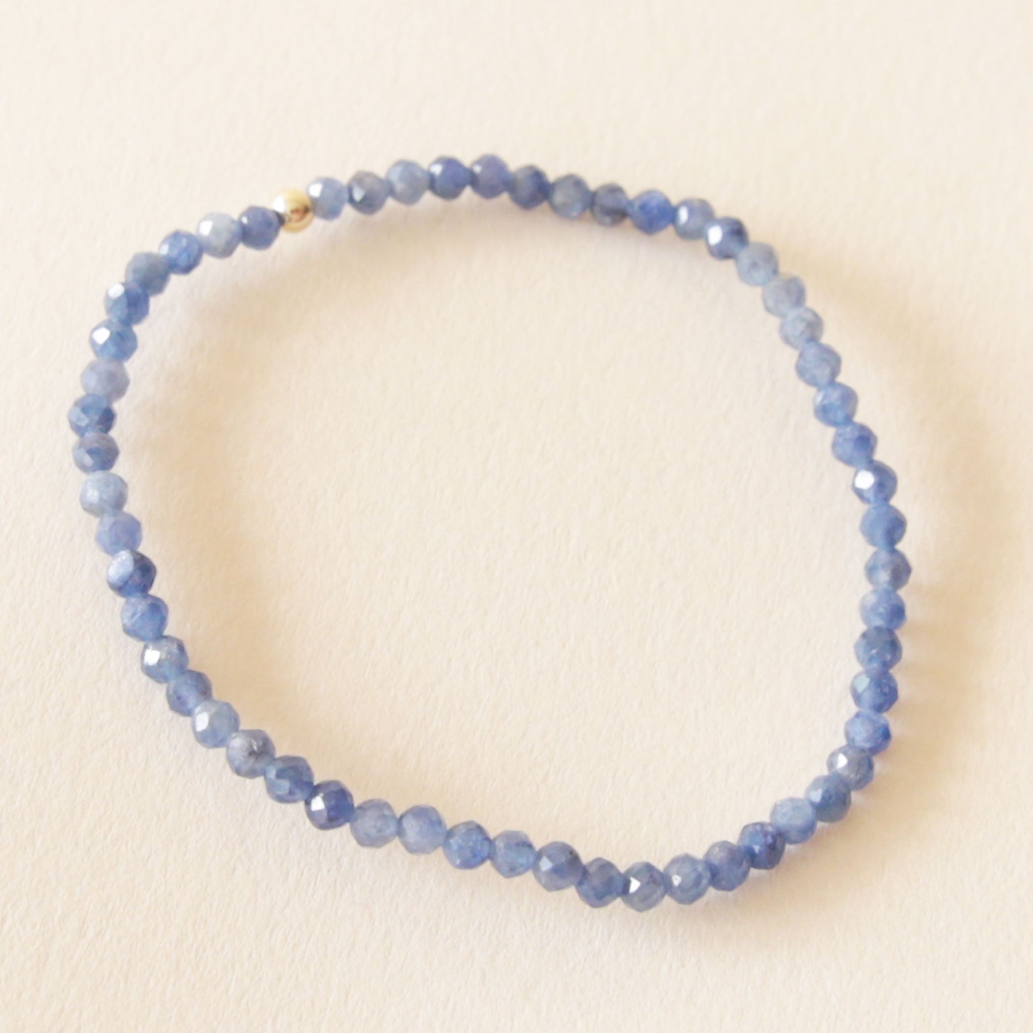 On a neutral background is a blue beaded Sapphire bracelet. 
