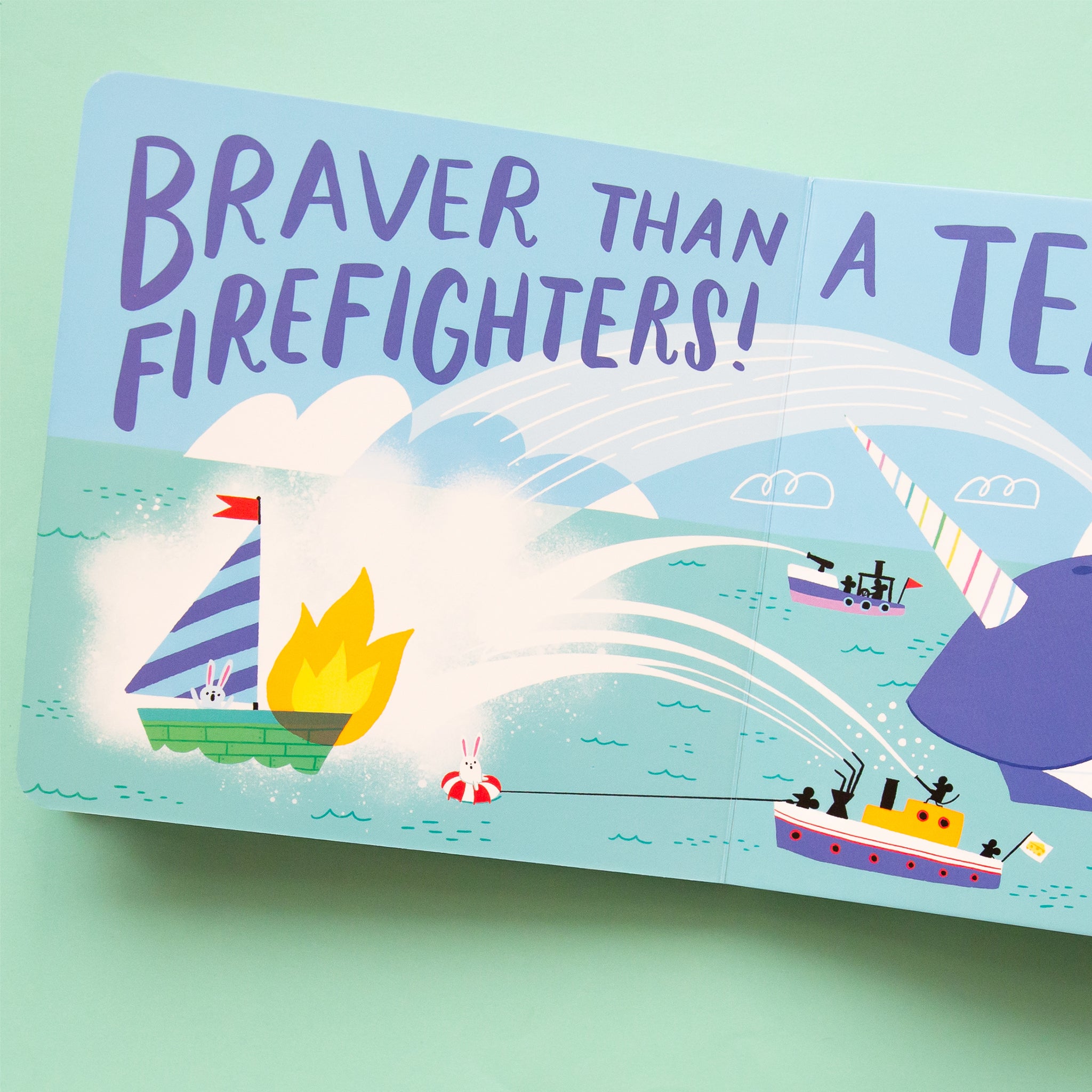 The blue book opened to a page with an illustration that reads, &quot;Braver Than A Team of Firefighters!&quot;. 