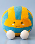 A blue and yellow stuffed toy in the shape of a volleyball with adorable legs, feet and a smiling face.