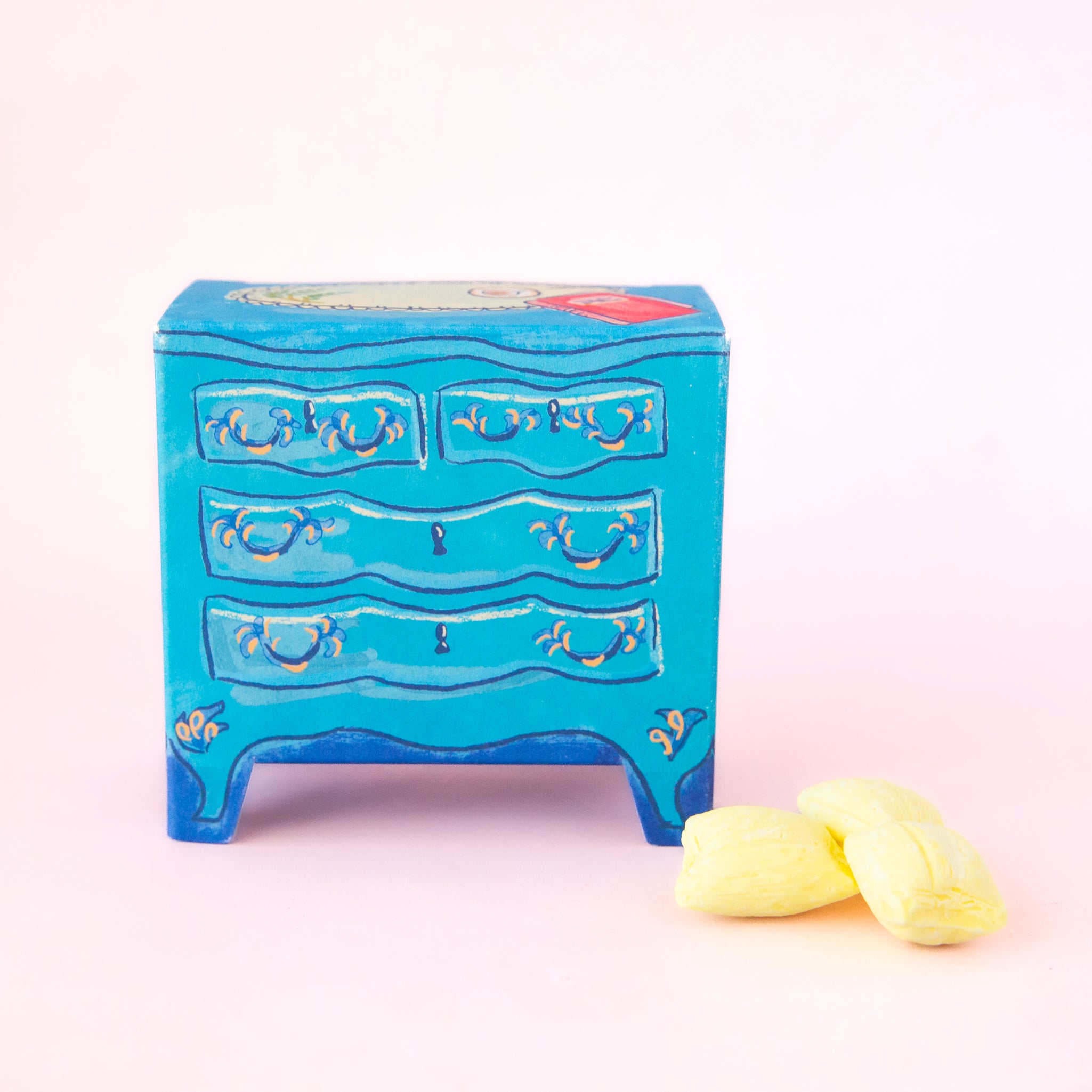A blue packaging of candy that looks like a dresser. 
