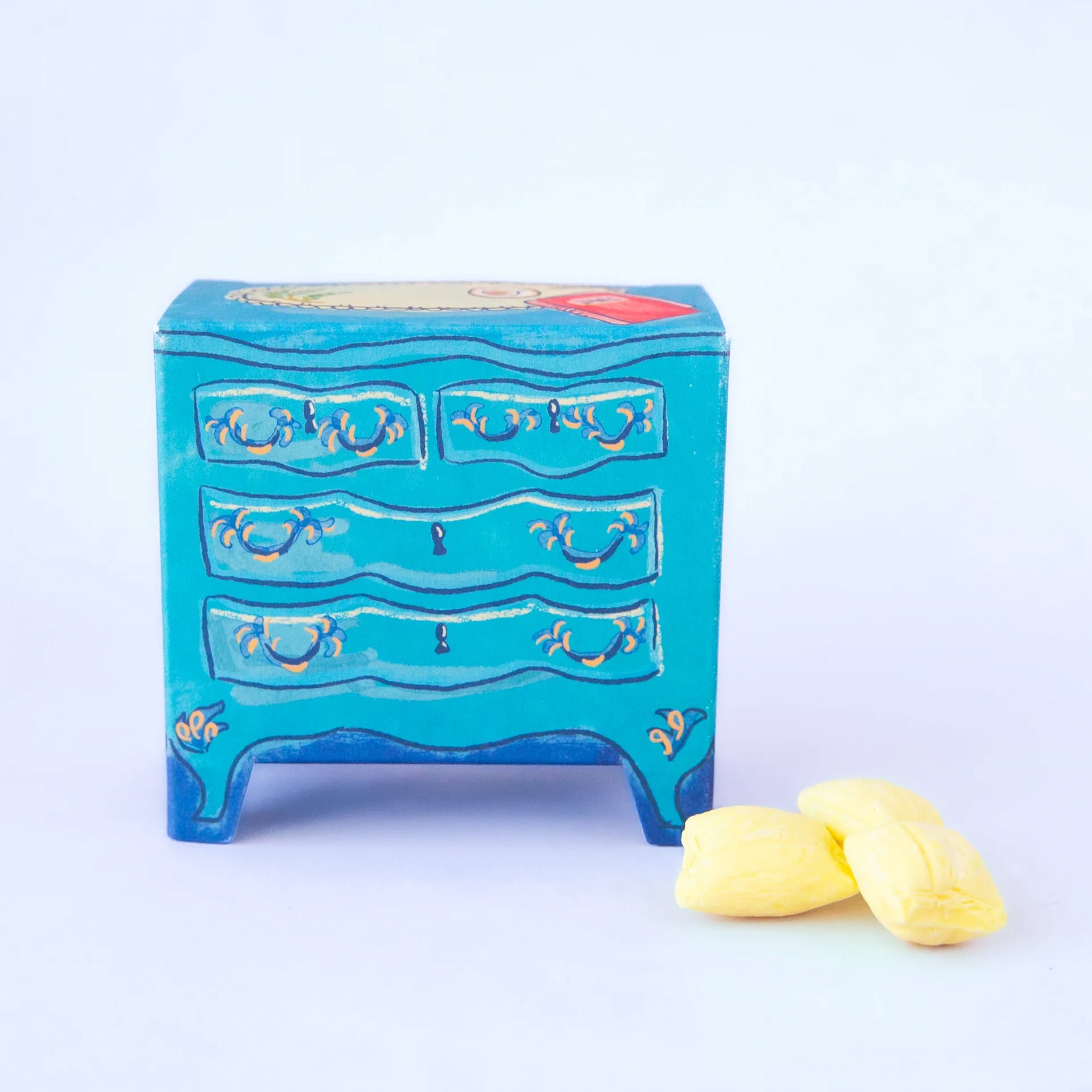 A blue packaging of candy that looks like a dresser. 