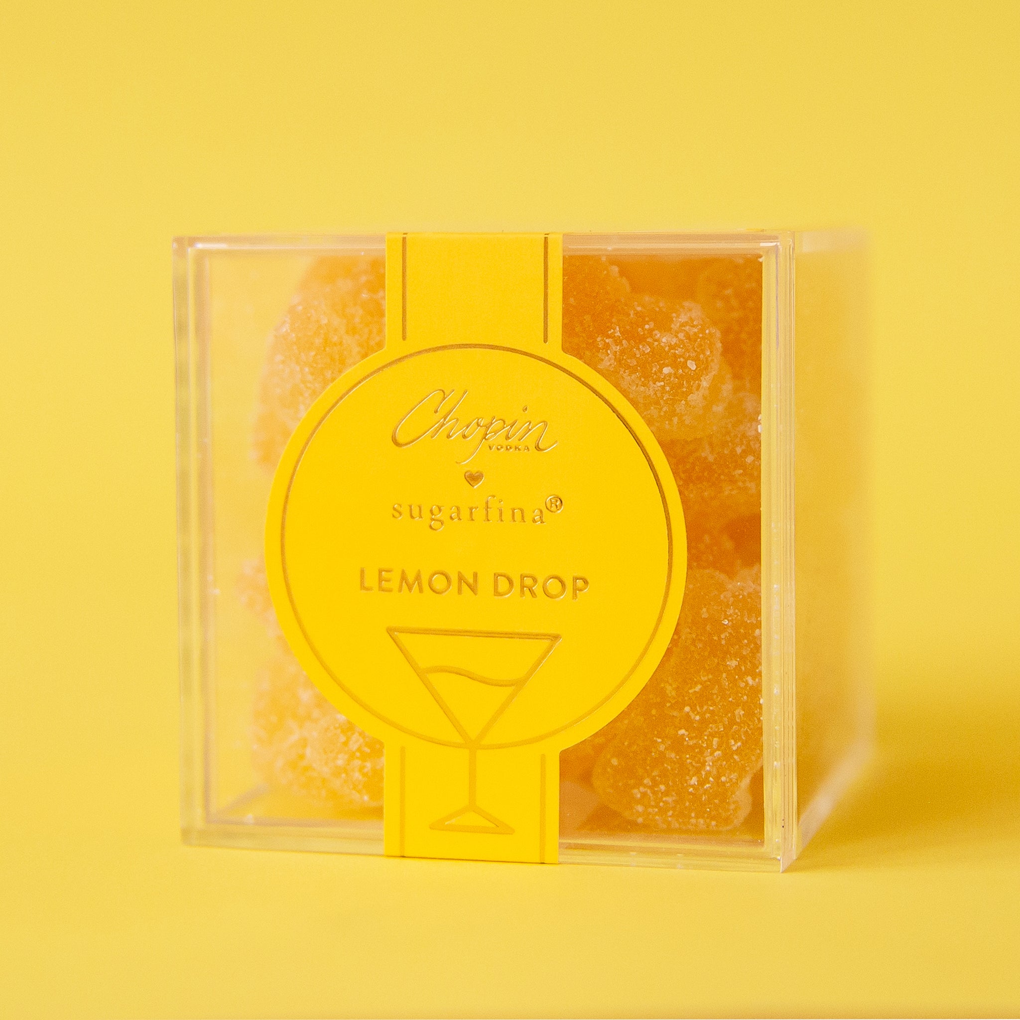 A clear acrylic box of yellow lemon drop flavored gummy bears.