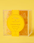A clear acrylic box of yellow lemon drop flavored gummy bears.
