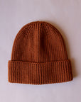A brown knit beanie. 