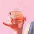 A short glass tumbler with white screenprinted text that reads, "Yee-haw Bitches".