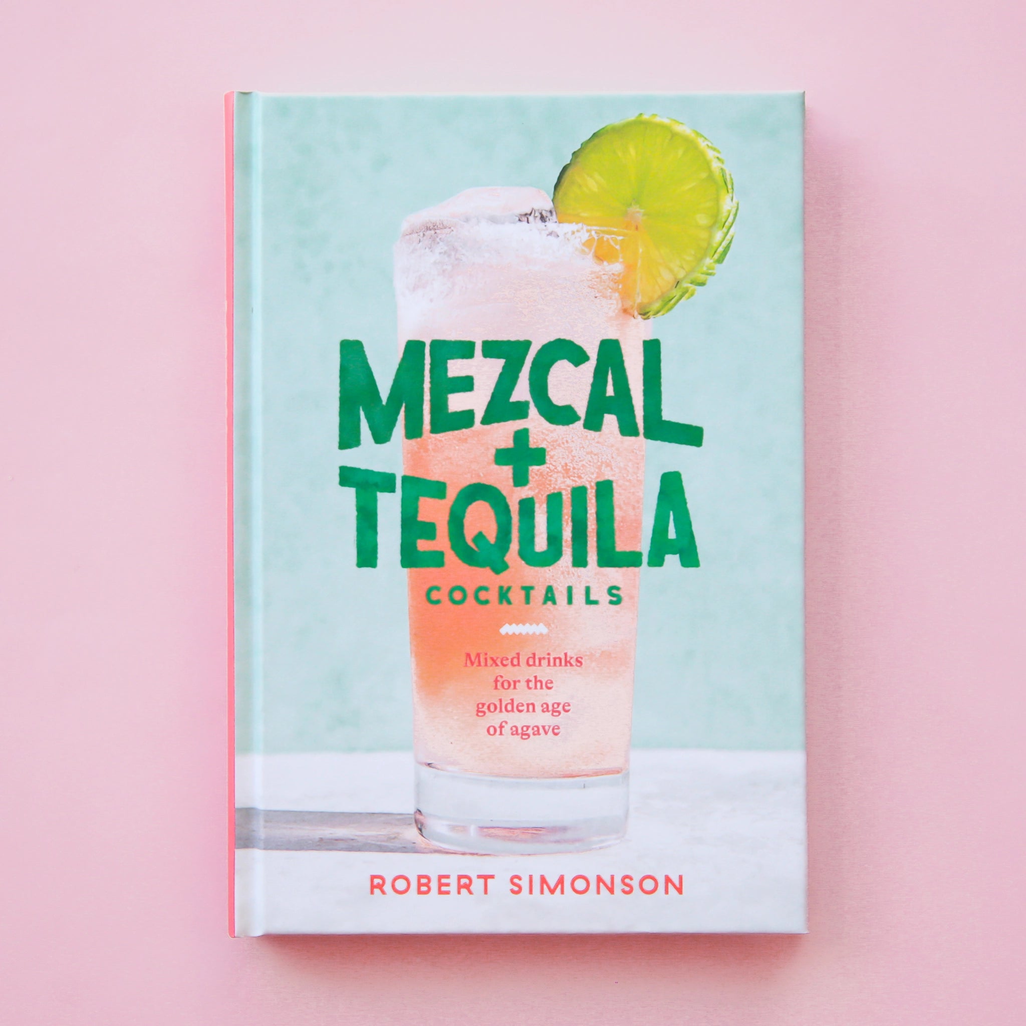 A light blue book cover with a pink tropical cocktail on the front with the title, "Mezcal + Tequila Cocktails" in teal blue lettering.