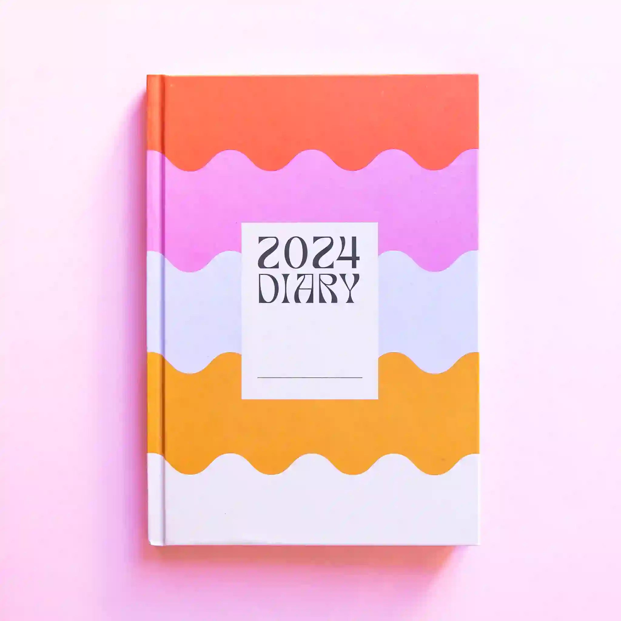 A rainbow wavy design diary with a white square in the center and black text that reads, &quot;2024 Diary&quot;.