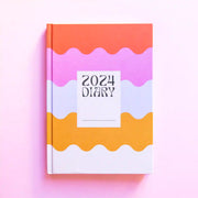 A rainbow wavy design diary with a white square in the center and black text that reads, "2024 Diary".