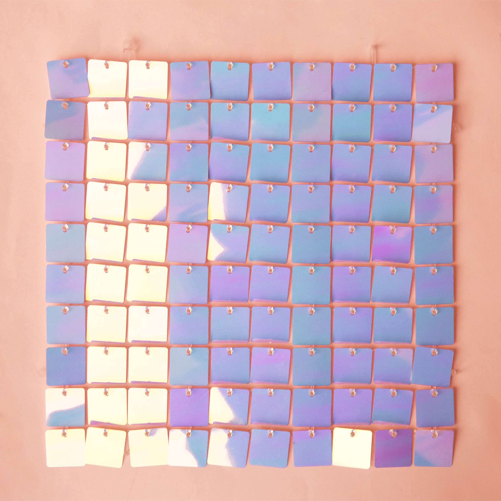 On a peachy background is a purple/blue shiny decorative wall panel.