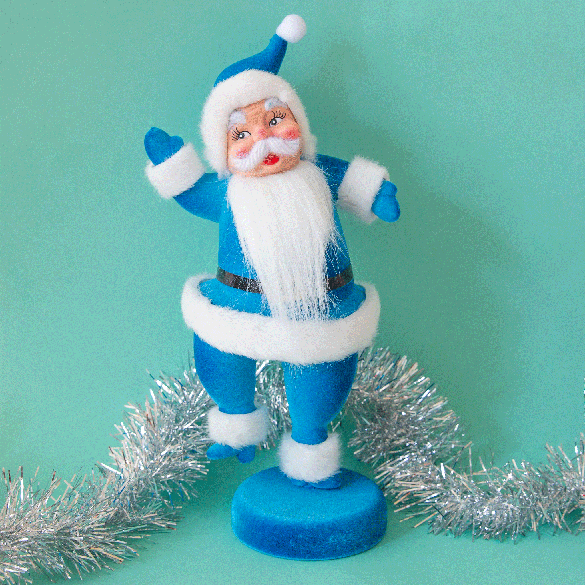 A blue Santa Christmas decoration with blue velvet suit on.