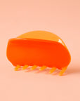 A two-toned rounded claw clip in shades of orange.