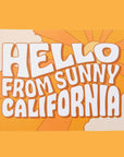 An orange postcard with 70's style text that reads, "Hello From Sunny California".