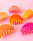All three of our two-toned claw clips side by side in tones of pink and orange.