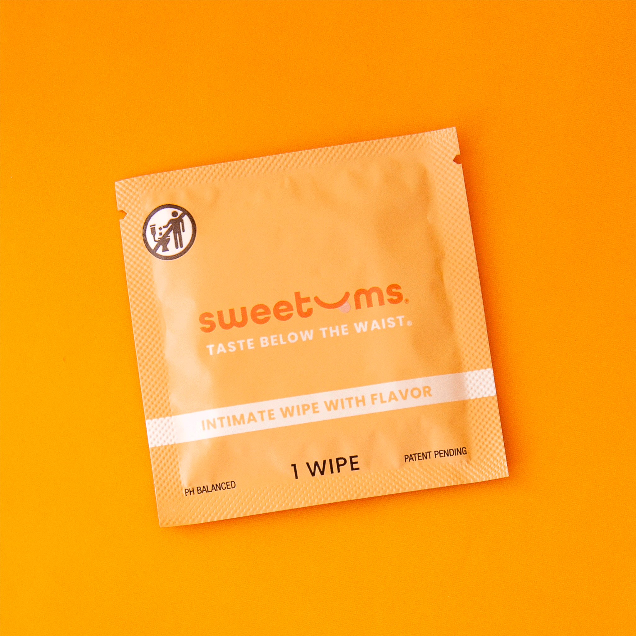 On an orange background is an orange packet of a single use feminine wipe. 