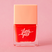 On a pink background is a red nail polish in a square bottle.