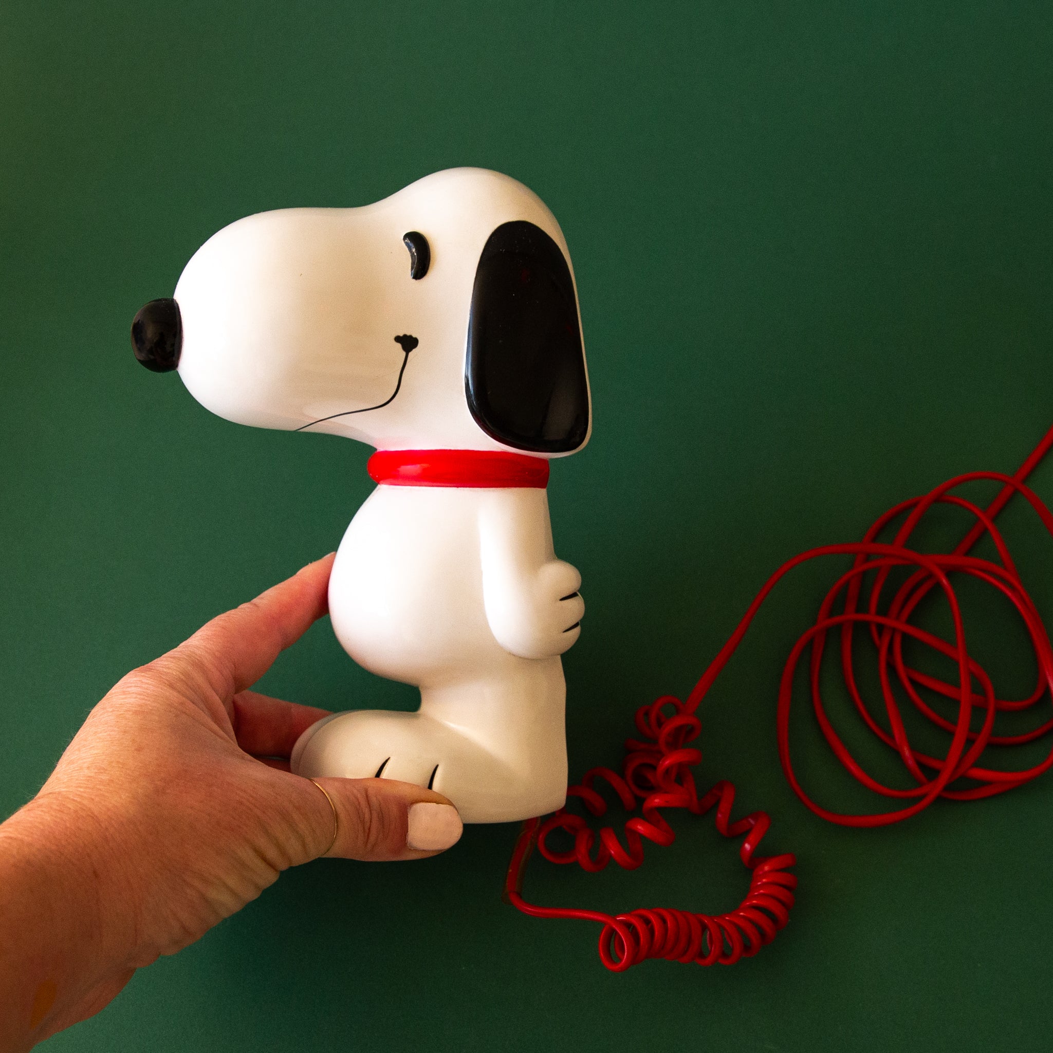 A Snoopy shaped vintage corded telephone. 