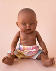 A pair of pastel checkered shorts on a Minikane doll that is sold separately.