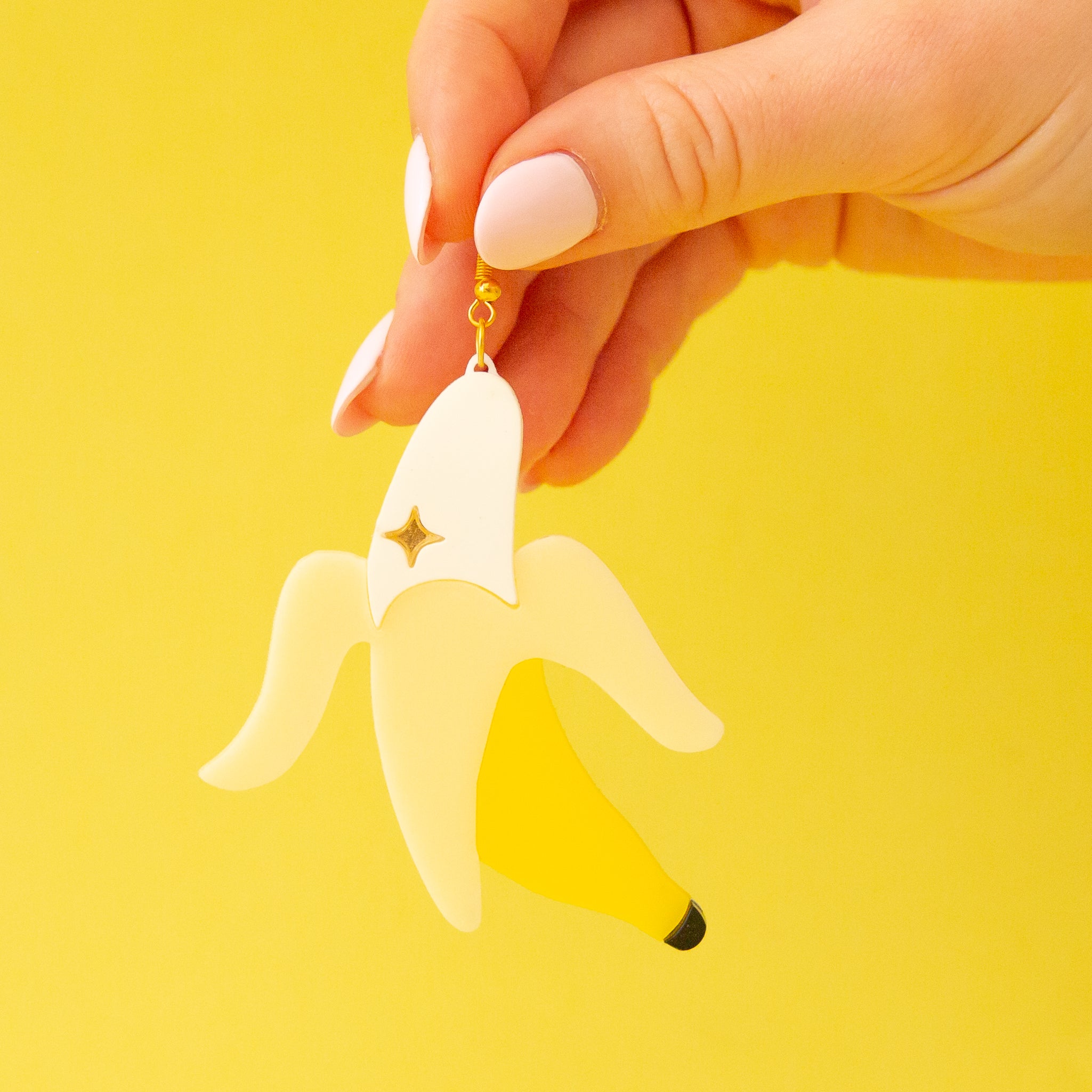 Banana shaped earrings with a gold plated hook.