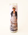 On a white background is a prayer candle with Harry Styles in a dress on the front. 
