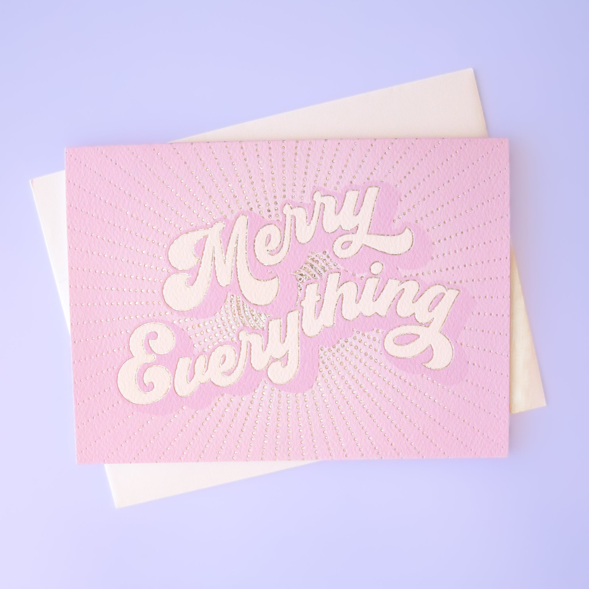 A lilac purple card with white text that reads, "Merry Everything". 