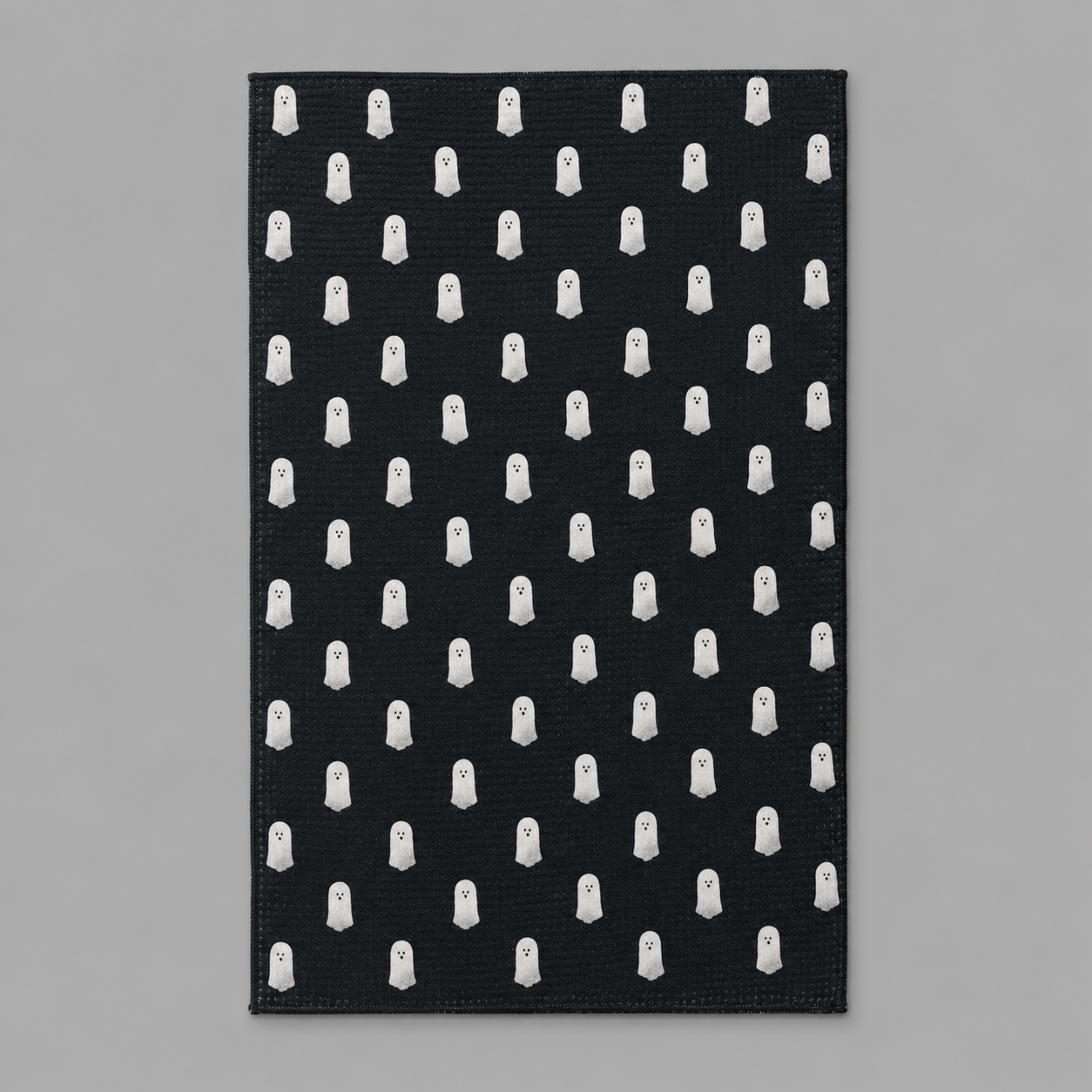 black tea towel with white ghost pattern. 