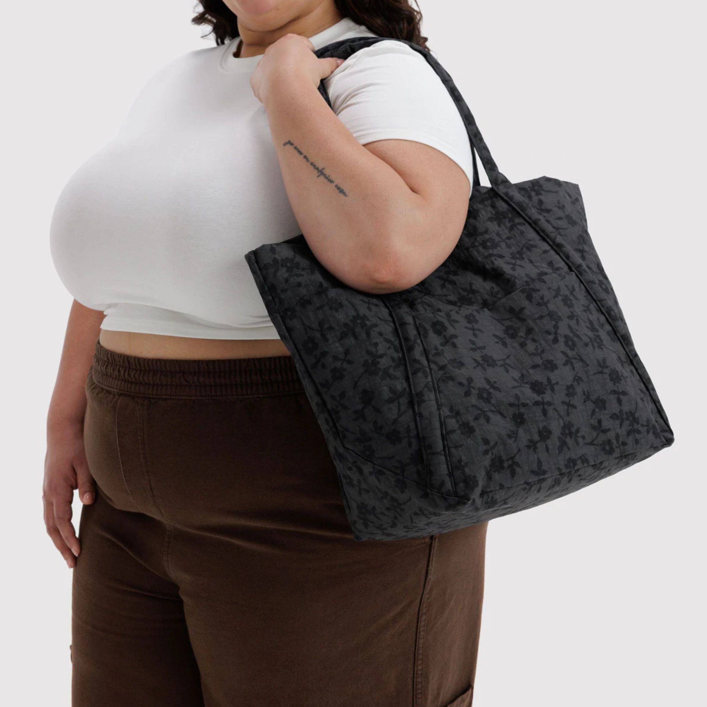 A black and grey tote bag with a floral pattern.
