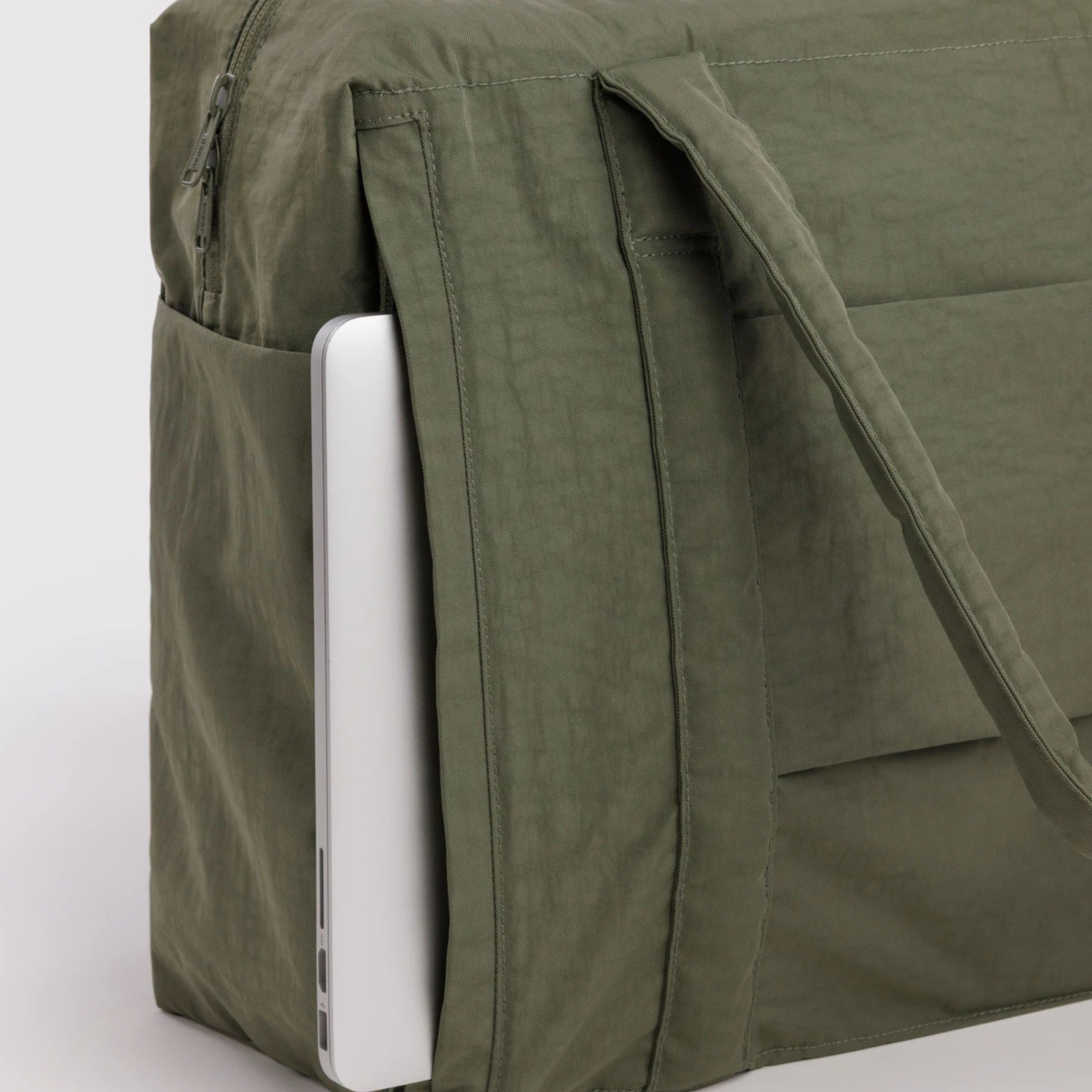 A green carry on bag. 