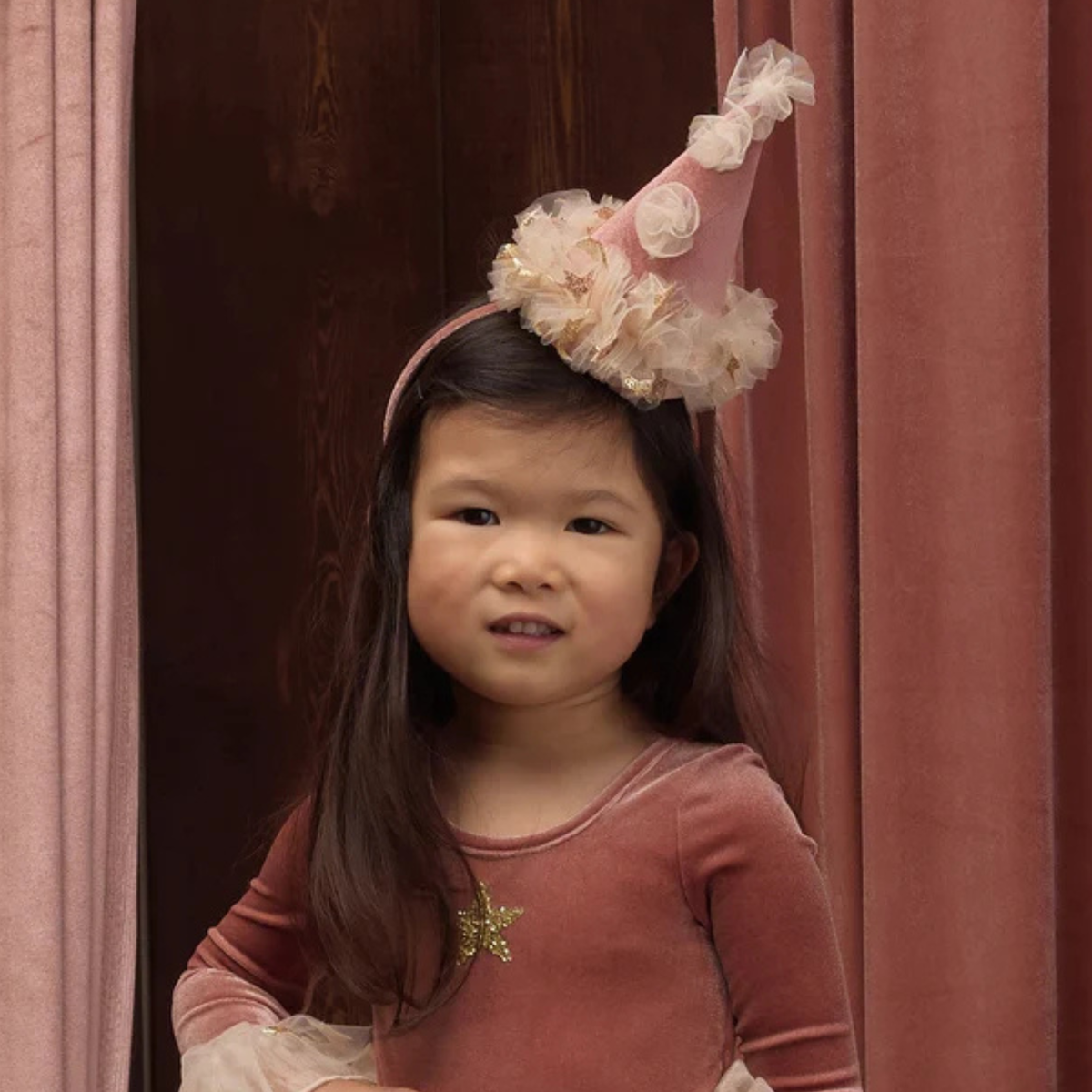 a pink tulle clown hat headband. 