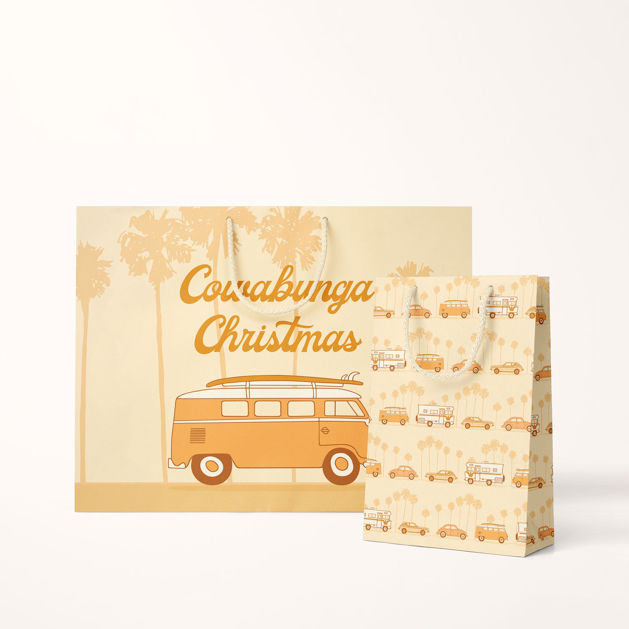 On a white background is a light orange gift bag with a VW bus graphic and rope details along with text that reads, &quot;Cowabunga Christmas&quot;.