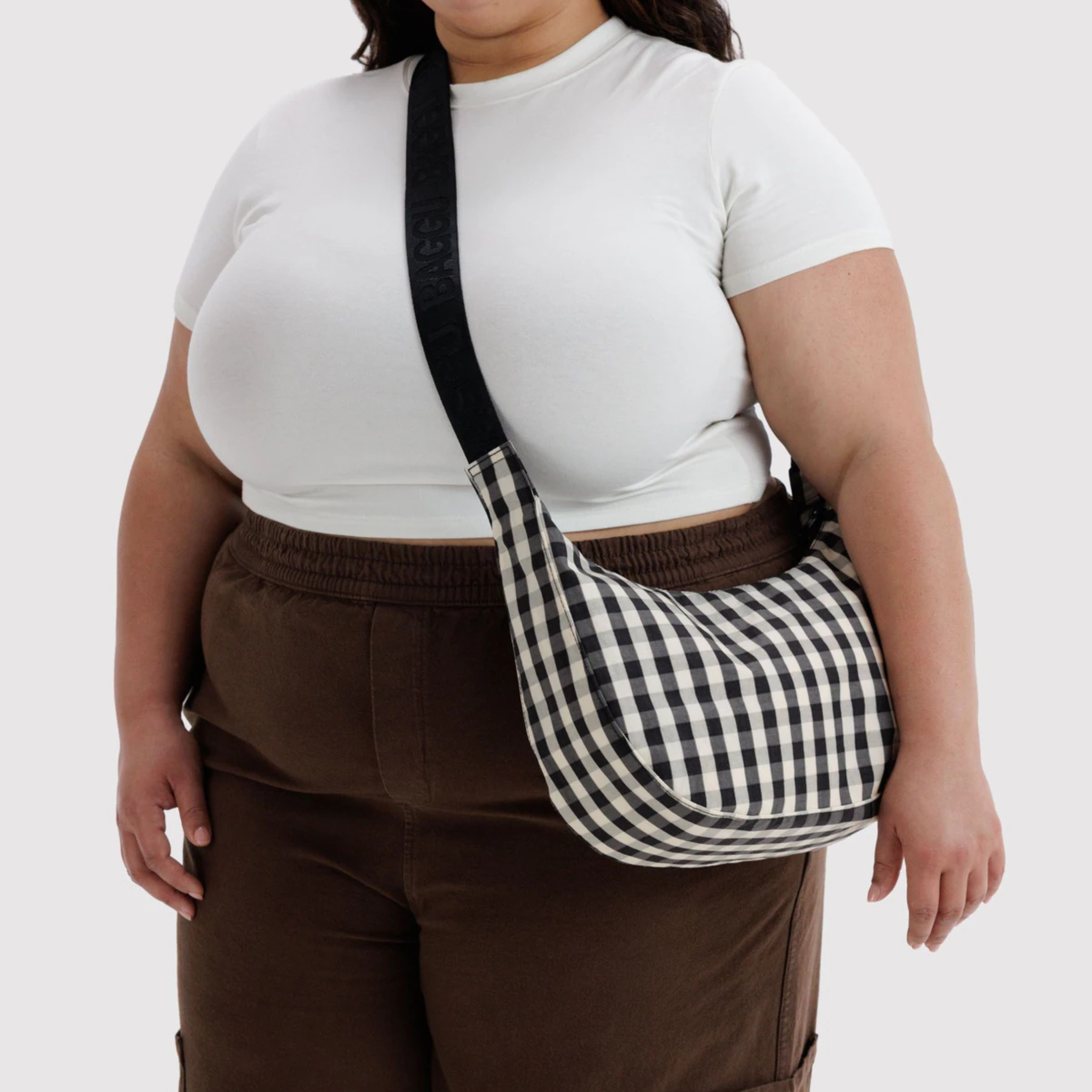 A black and cream gingham print shoulder bag.