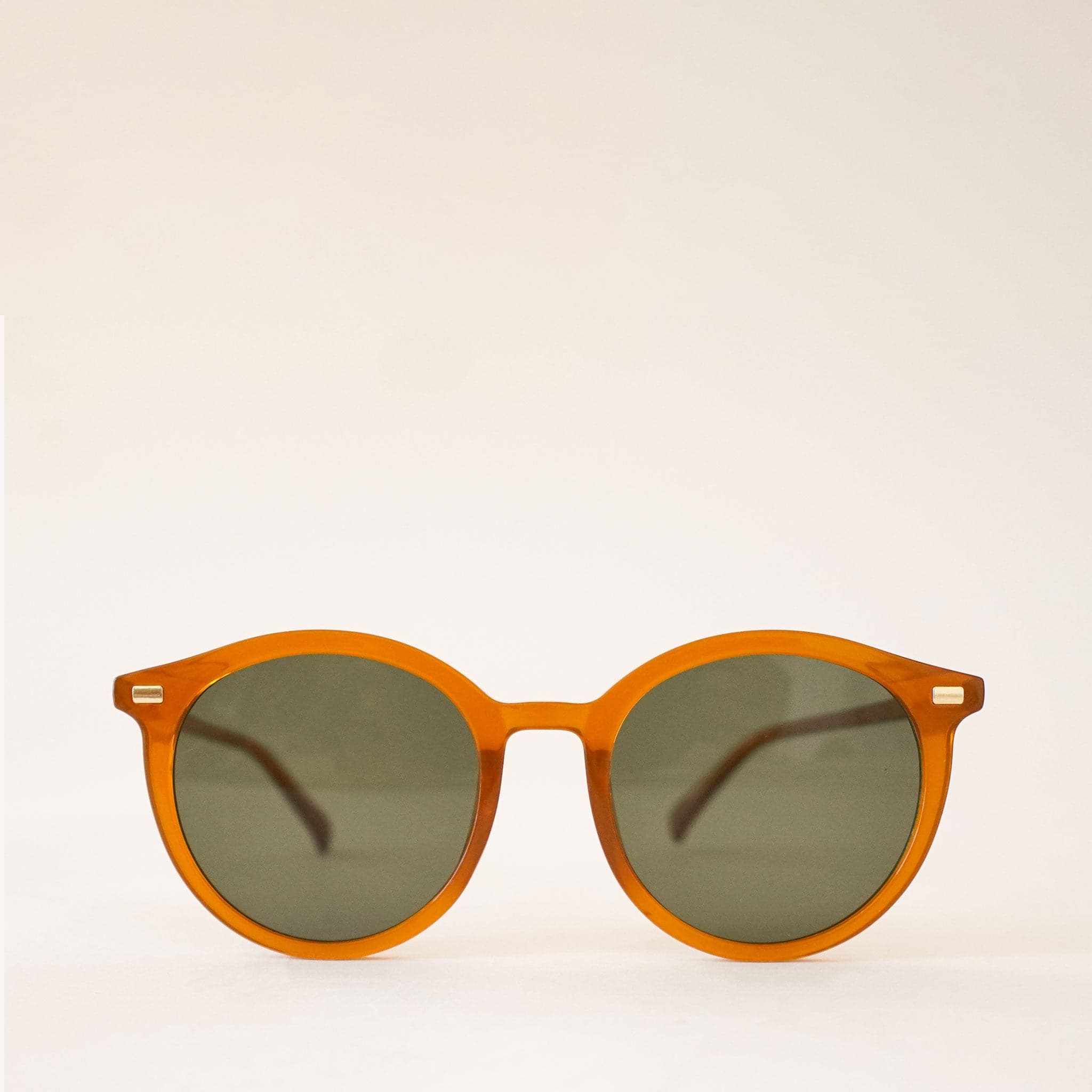 A thin rounded orange framed sunglass with a grey lens.