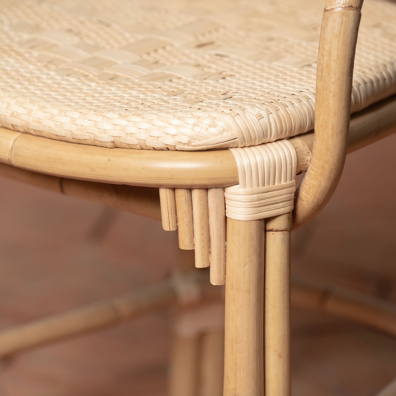 A closeup of the rattan chair and its woven cane detailing. 