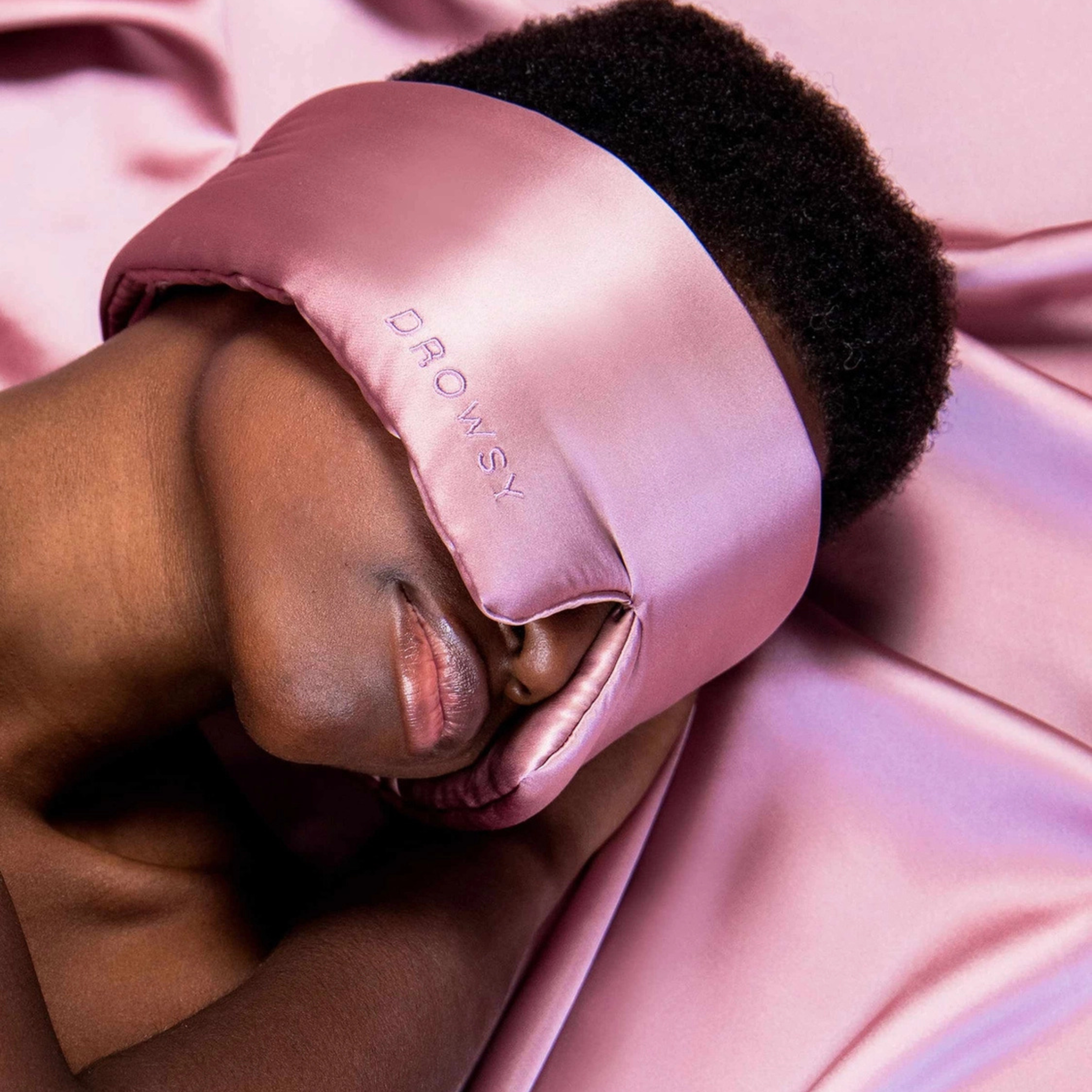 a dusty pink padded eye mask
