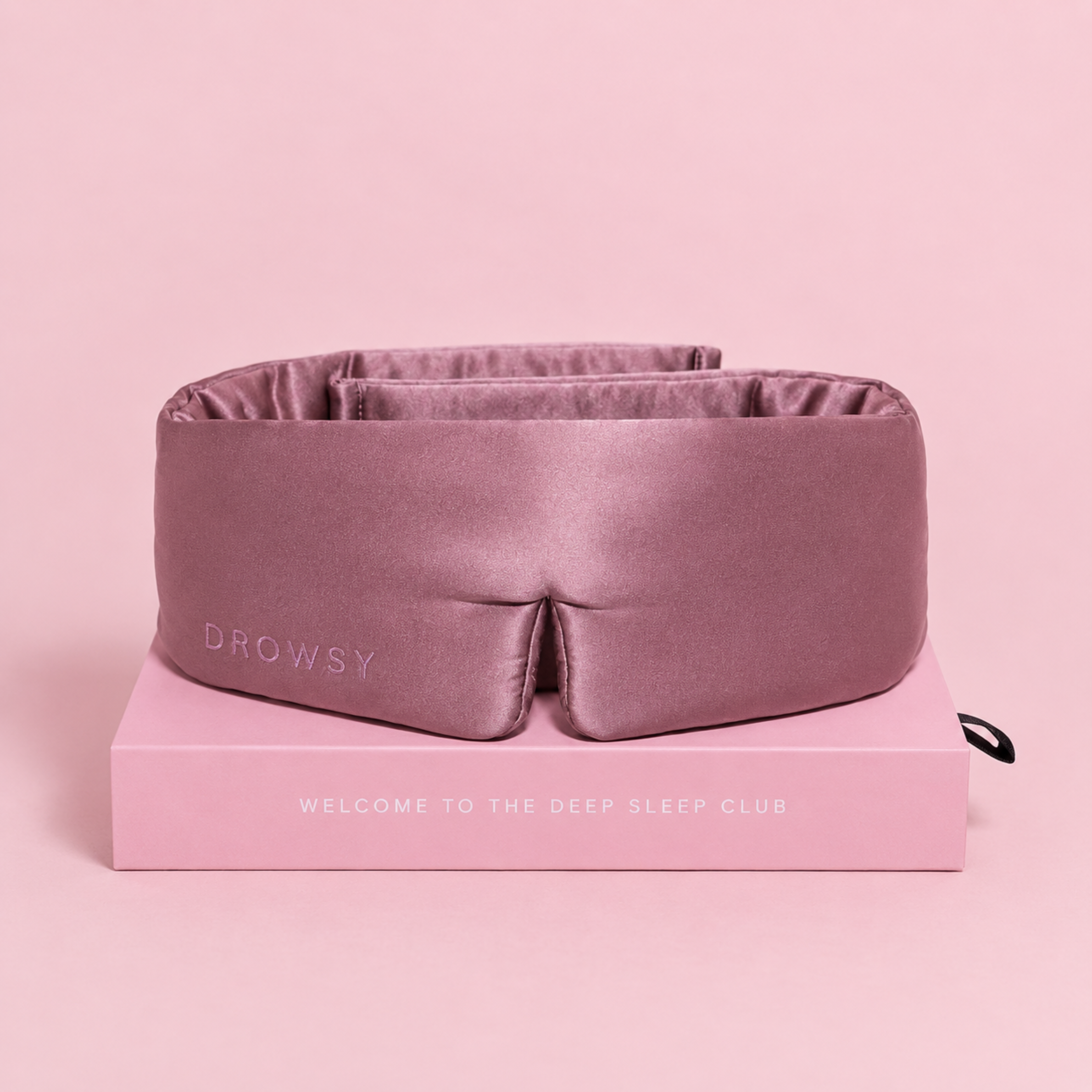 a dusty pink padded eye mask