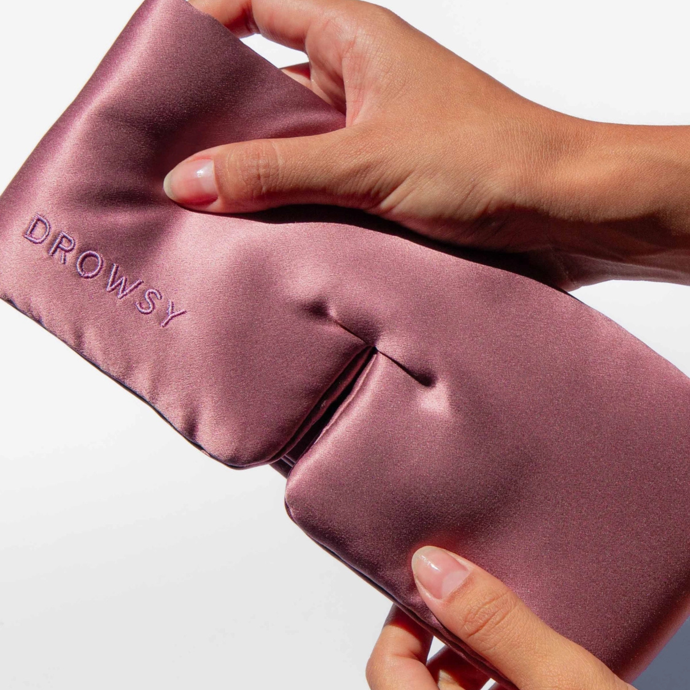a dusty pink padded eye mask