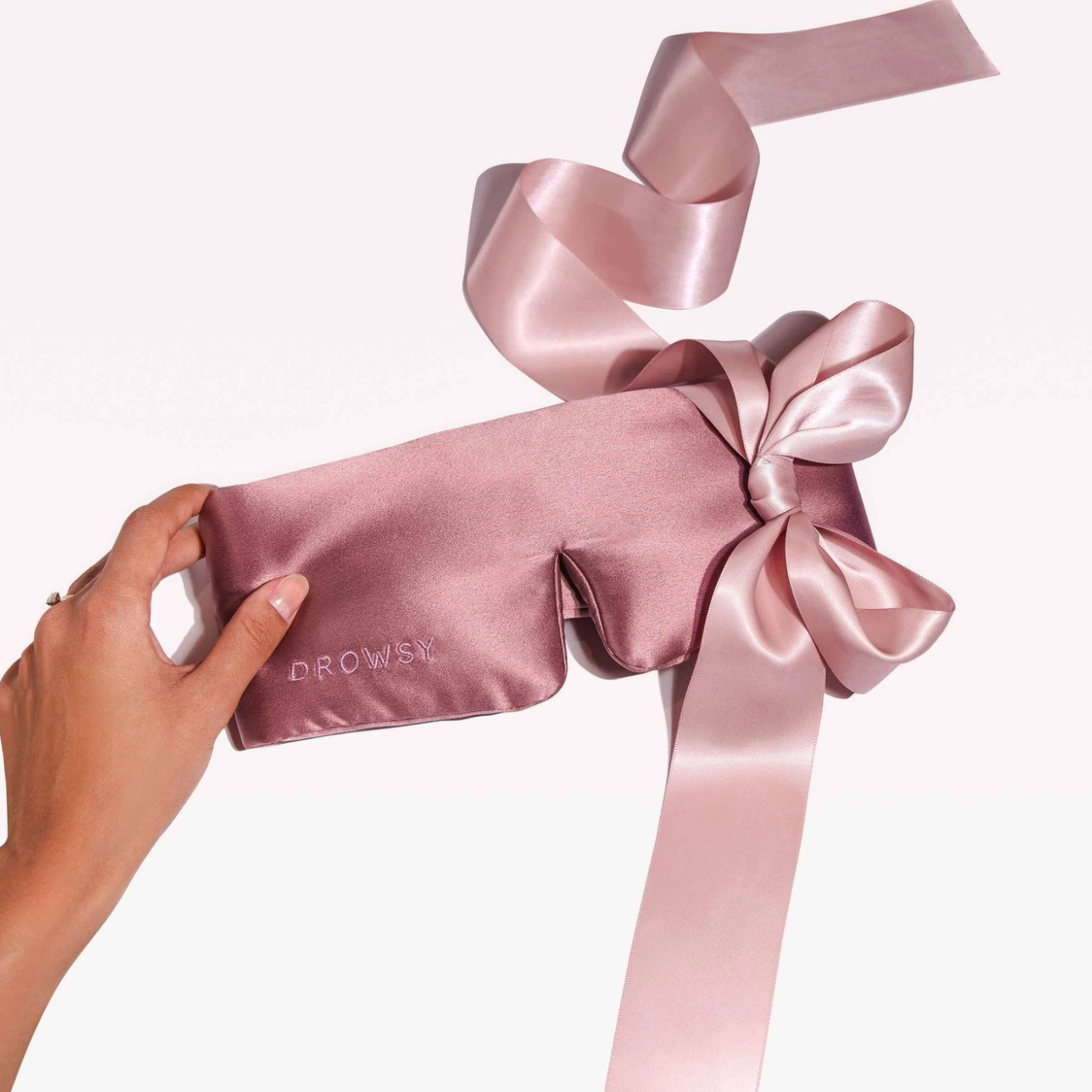 a dusty pink padded eye mask