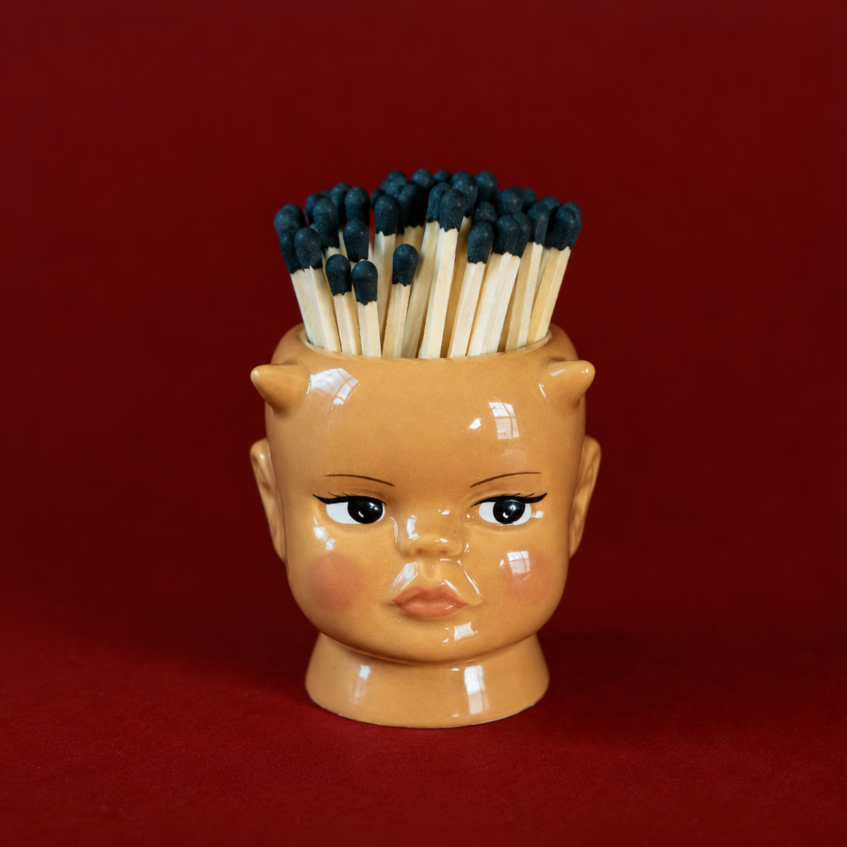 a demon doll shaped match holder