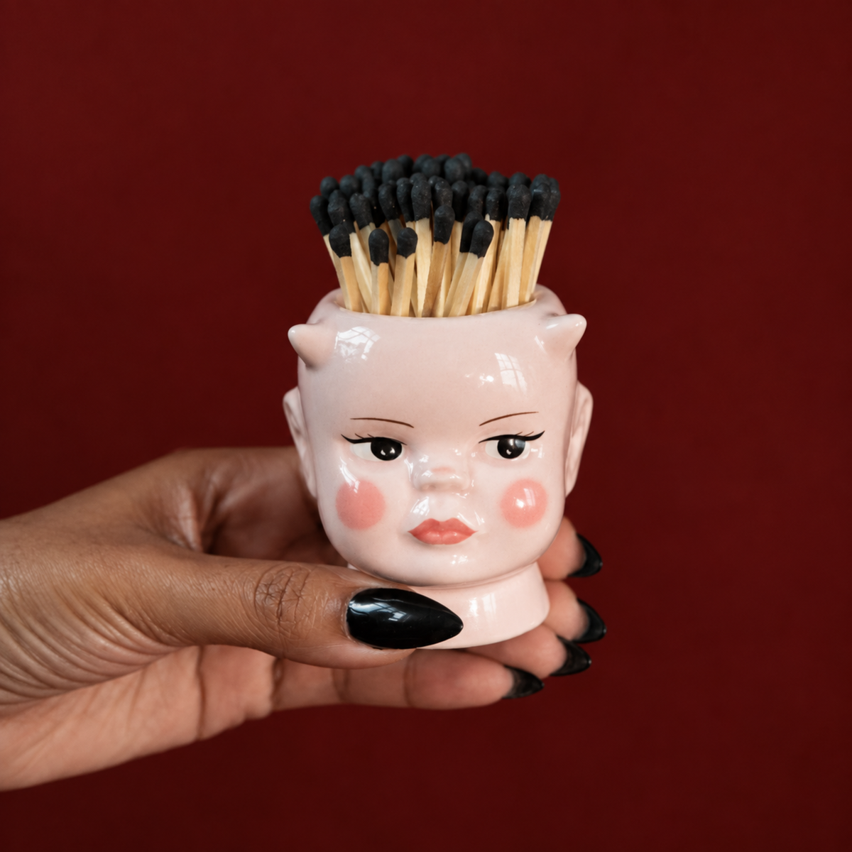 a demon doll match holder