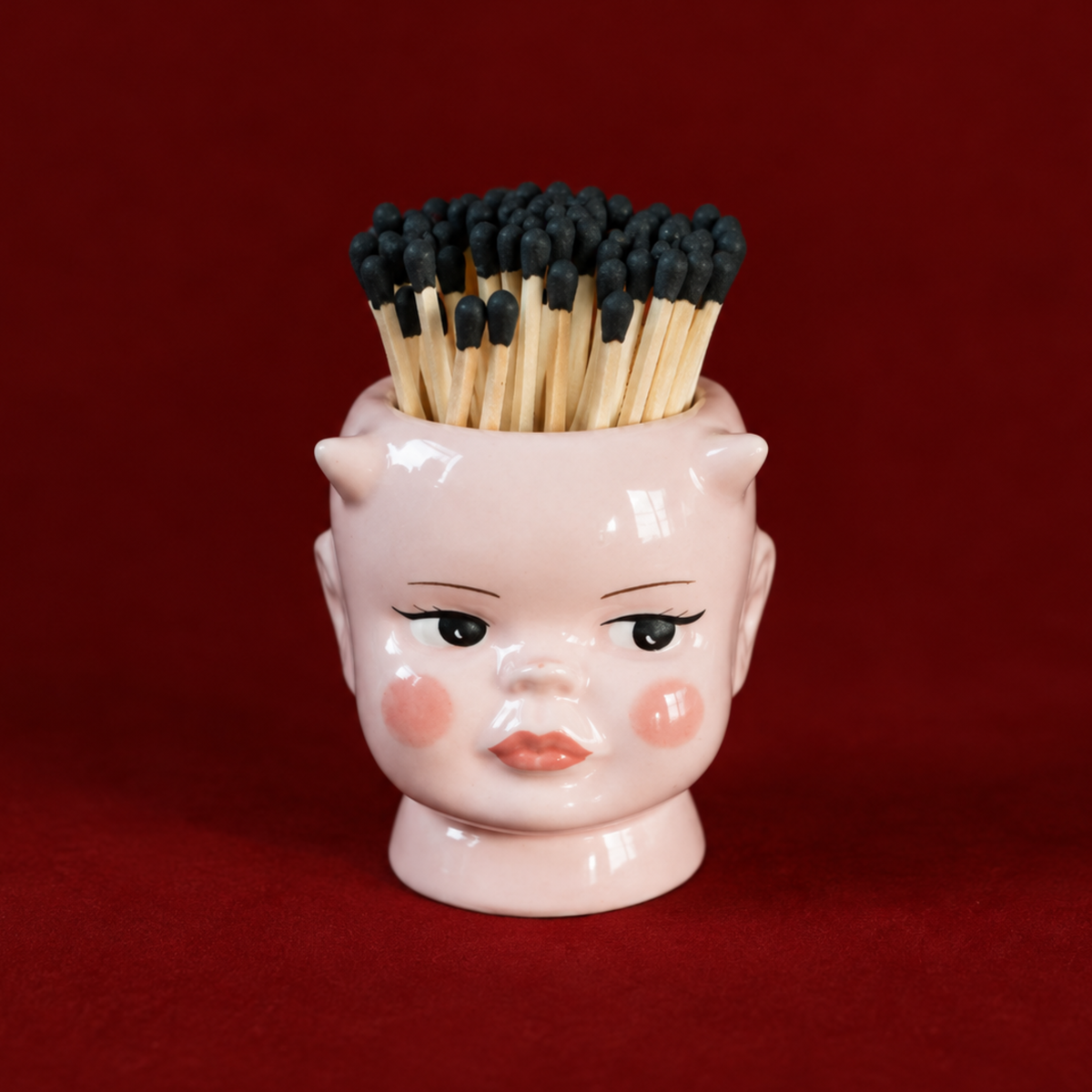 a demon doll match holder