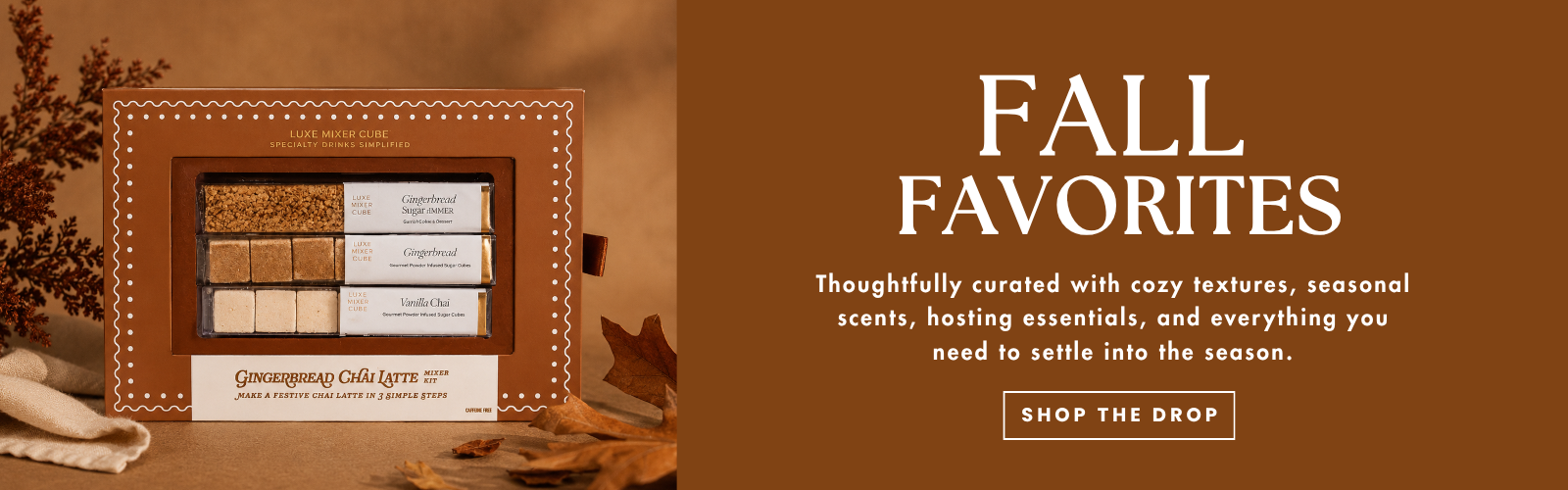 A promotional banner for 'Fall Favorites' featuring a framed display of scented candles on the left and marketing text on the right against a warm brown background.