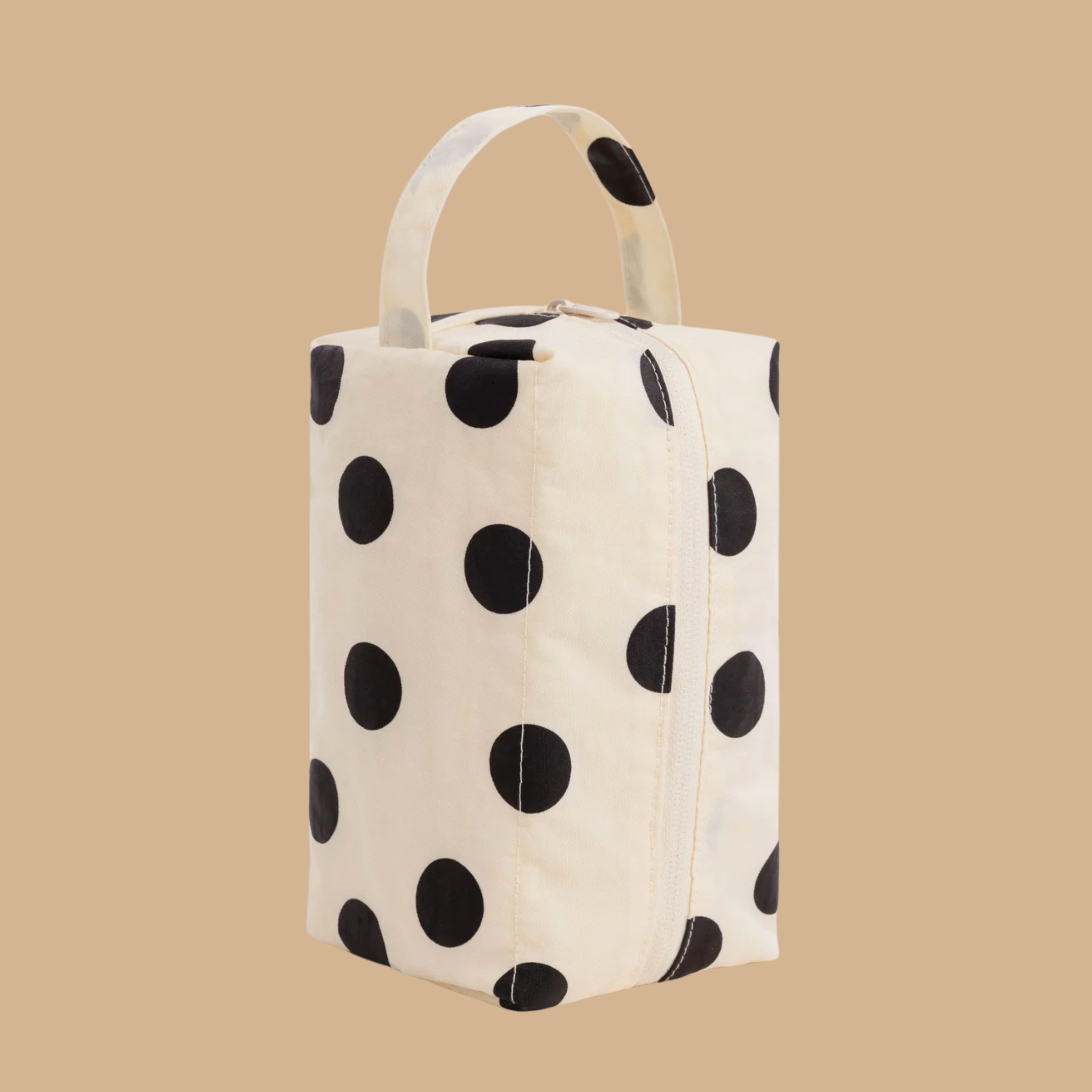 a cream and black polka dot dopp kit bag.