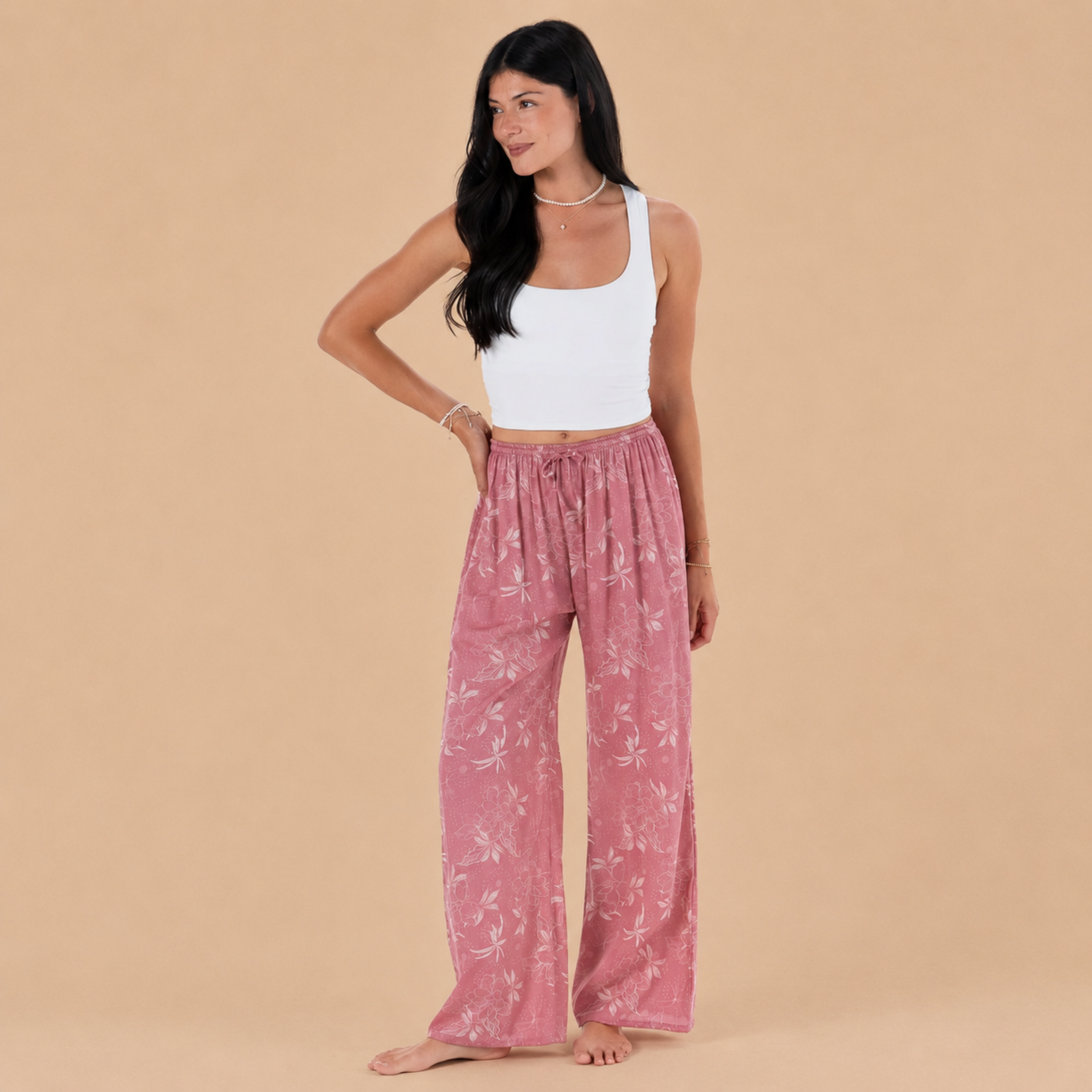 a pair of pink pants with a cream foliage print.
