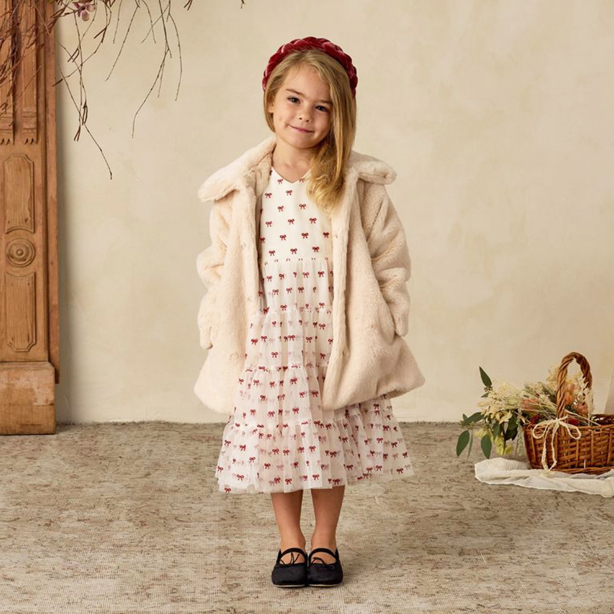 An ivory faux fur coat. 