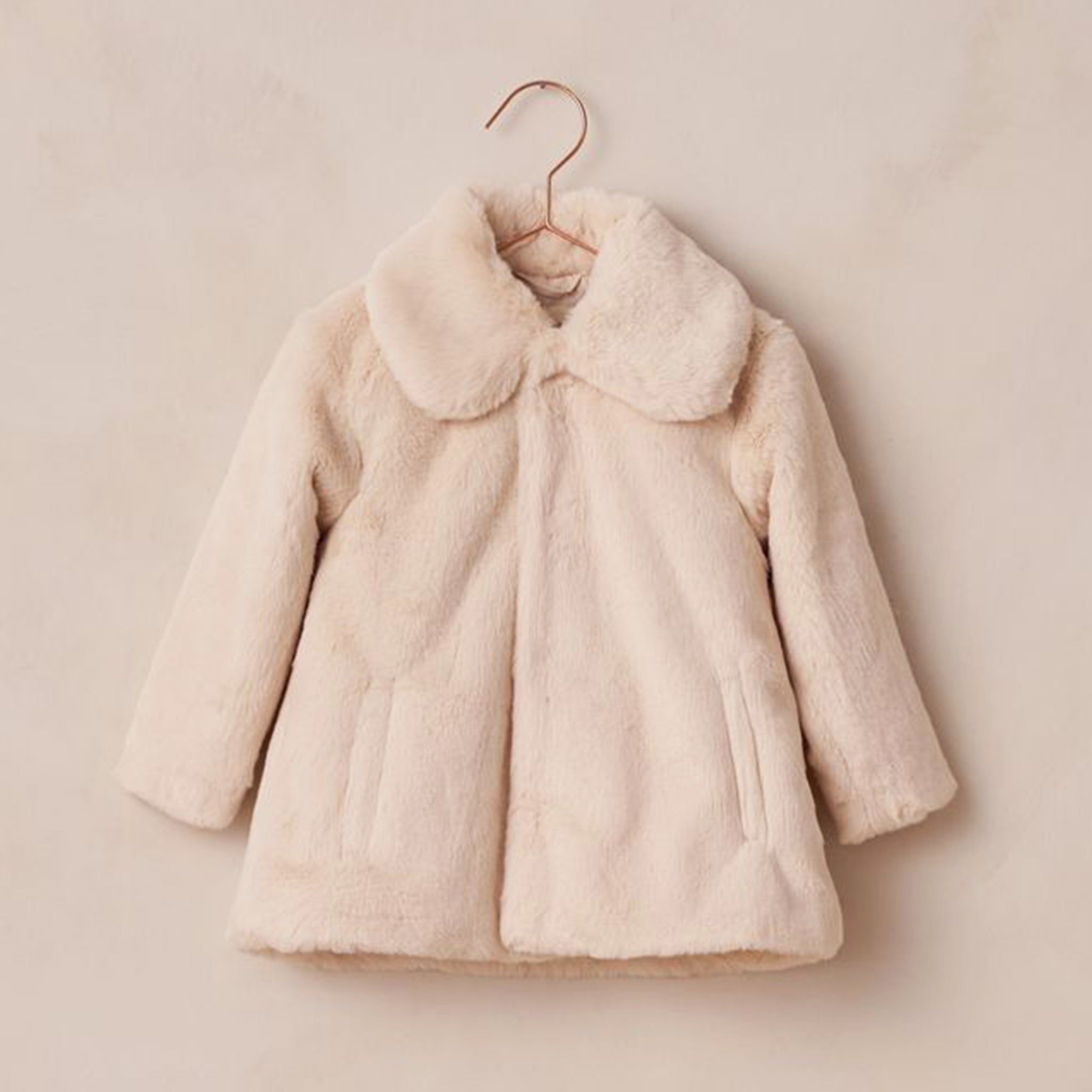 An ivory faux fur coat. 